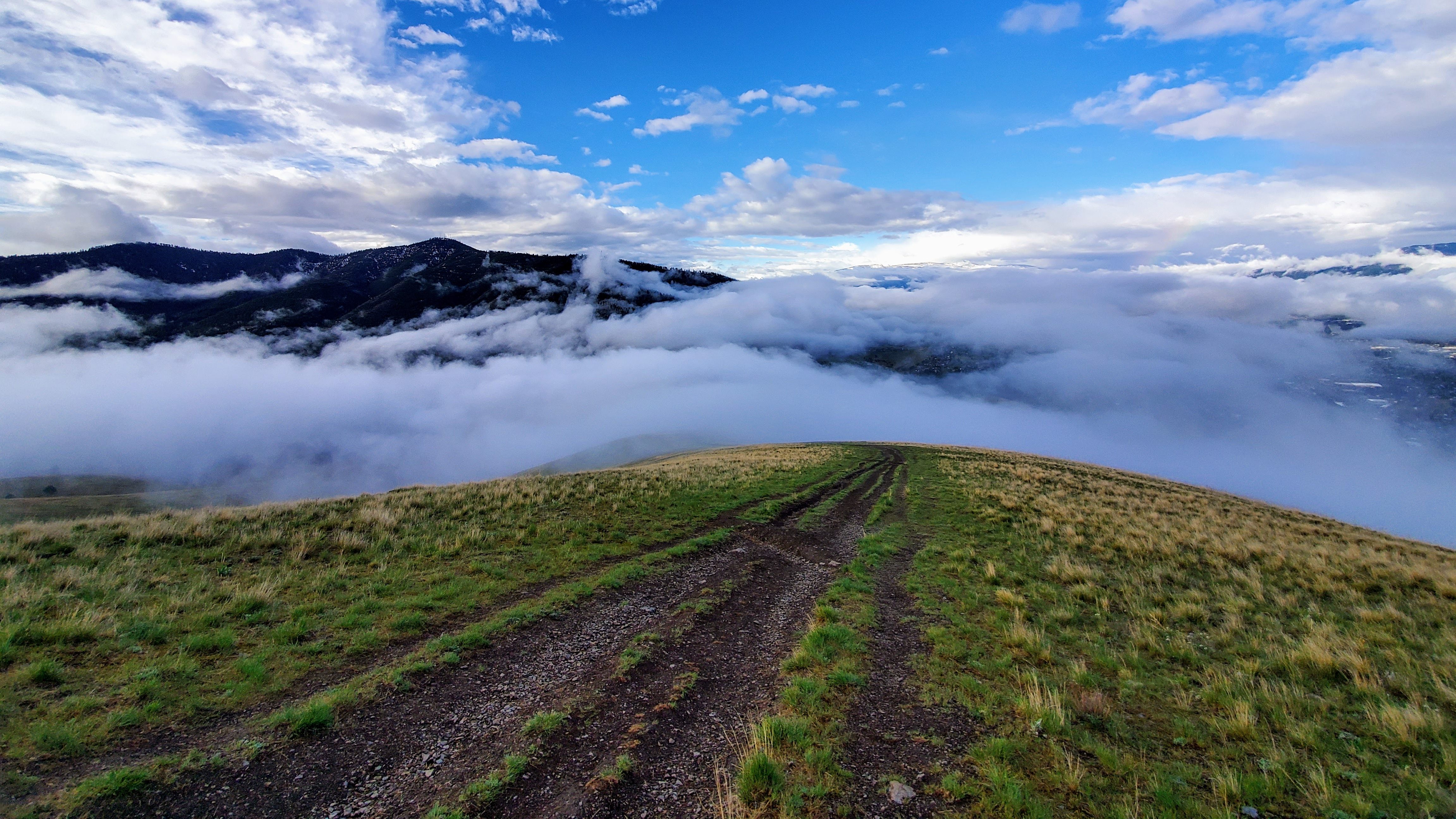 Mountain path rising up out of cloud filled valley.